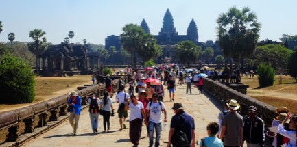 The main West entrance to Angkor Wat with a raised walkway for the king (the commoners had a separate entrance to the complex and could walk beside the main path). Naga (serpent) handrails visible everywhere through all the temples.